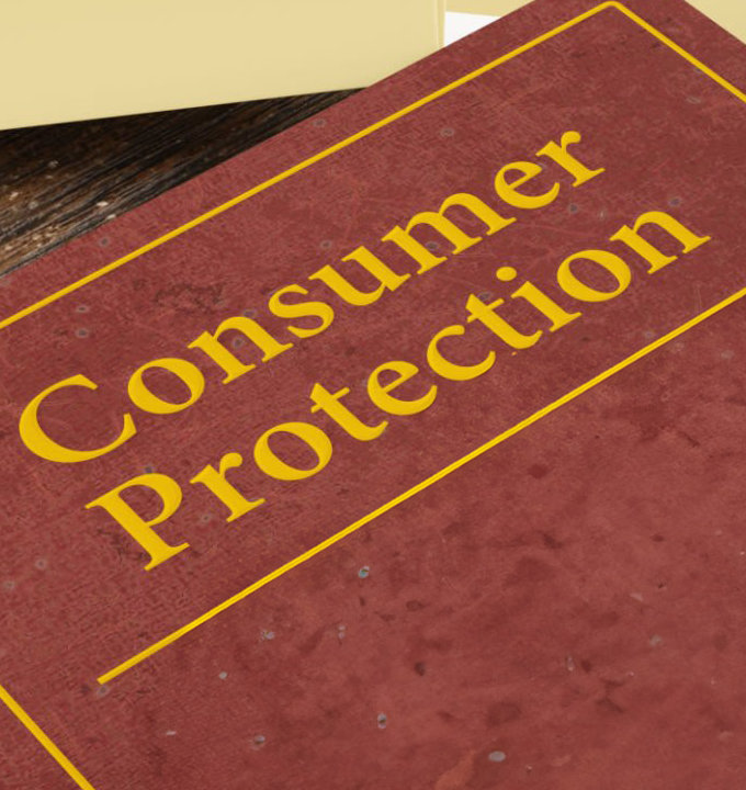 Consumer protection law book on a wooden desk.